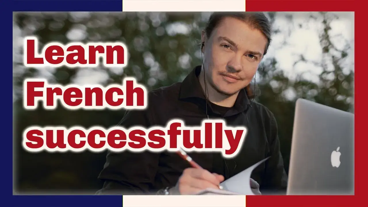 Angel Pretot looks at the camera writing with a pen in a notebook, a laptop on his lap, the words Learn French successfully in red outlined in white at left