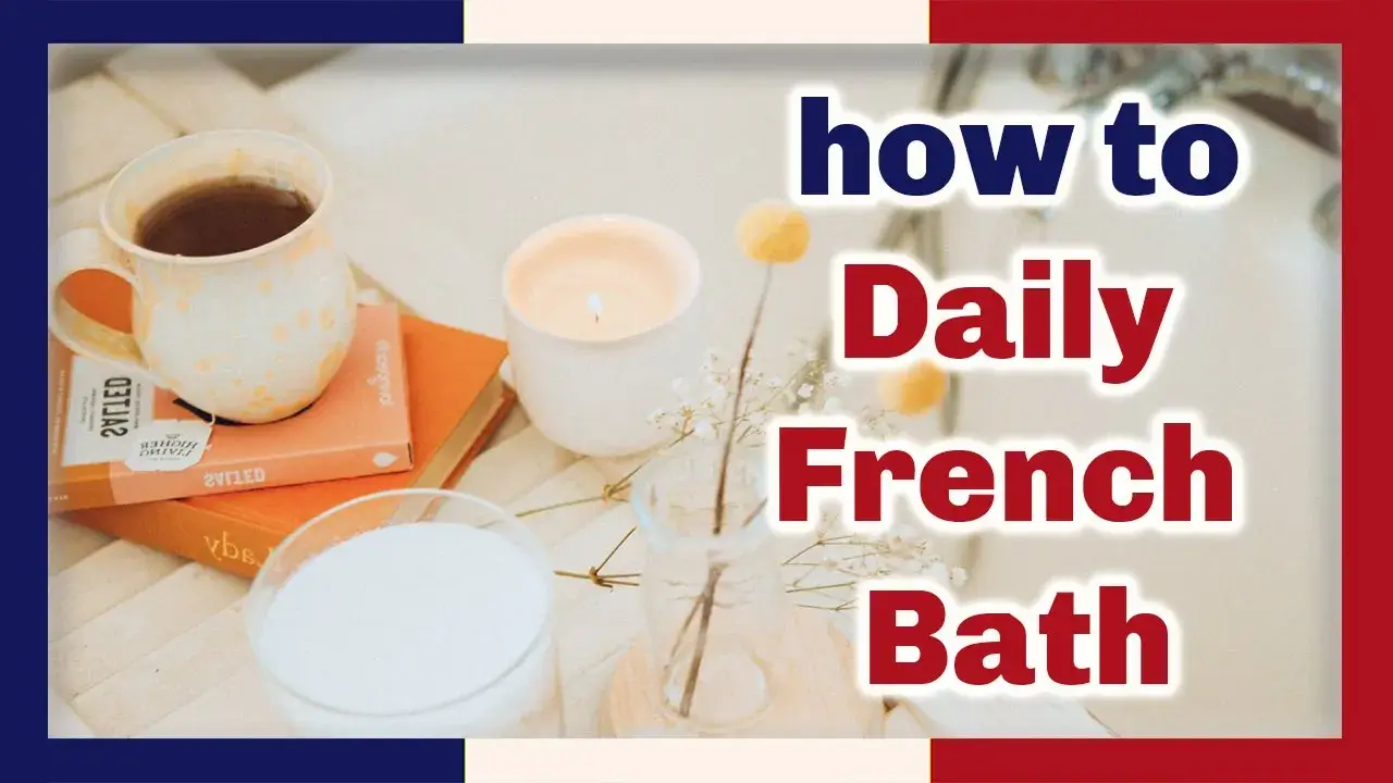 A cup of tea sits on top of two books, a white candle, glass of milk, and vase with two pale orange flowers at left, the words how to Daily French Bath in red and blue outlined in white at right
